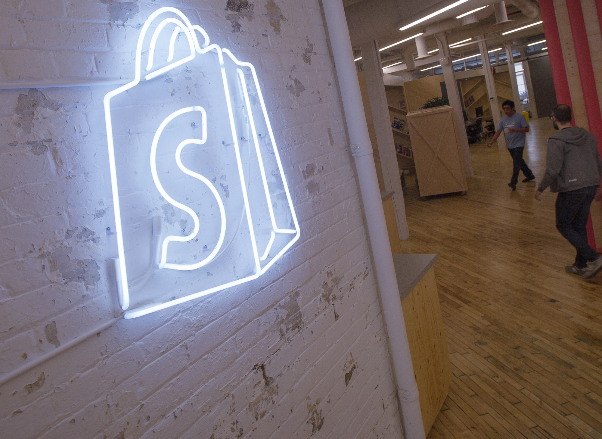 The logo of Shopify Inc. hangs on a wall at the company's office space in Toronto.
