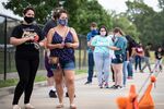 Patients wait in line at a walk up COVID-19 testing site at A+ Academy Secondary School on June 27, 2020 in Dallas, Texas.