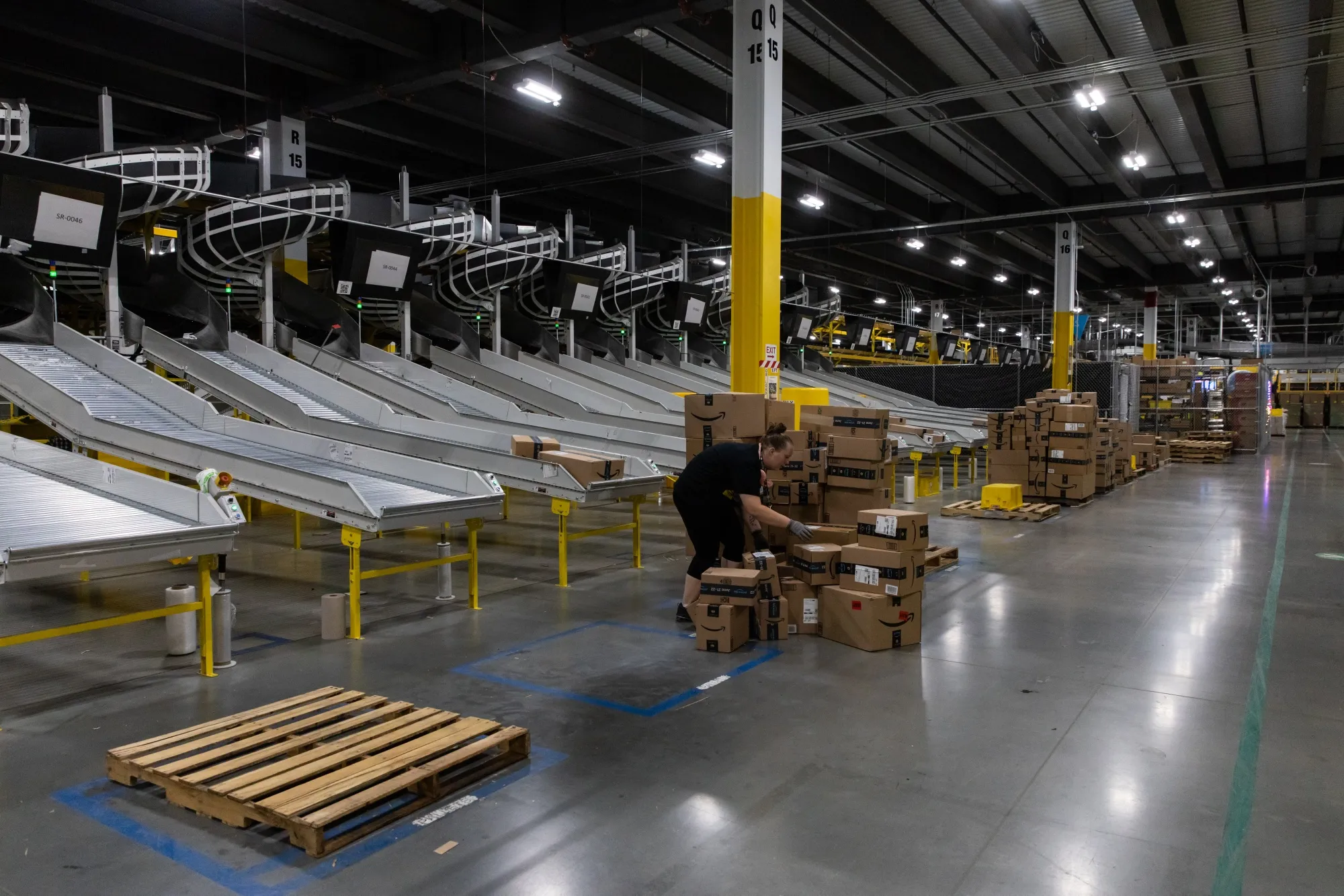 A worker loads boxes onto a pallet at an Amazon fulfillment center on Prime Day in Raleigh, North Carolina, U.S., on Monday, June 21, 2021. Amazon.com Inc.'s annual Prime Day sale, which begins Monday, arrives as the world grapples with the lingering effects of the pandemic.