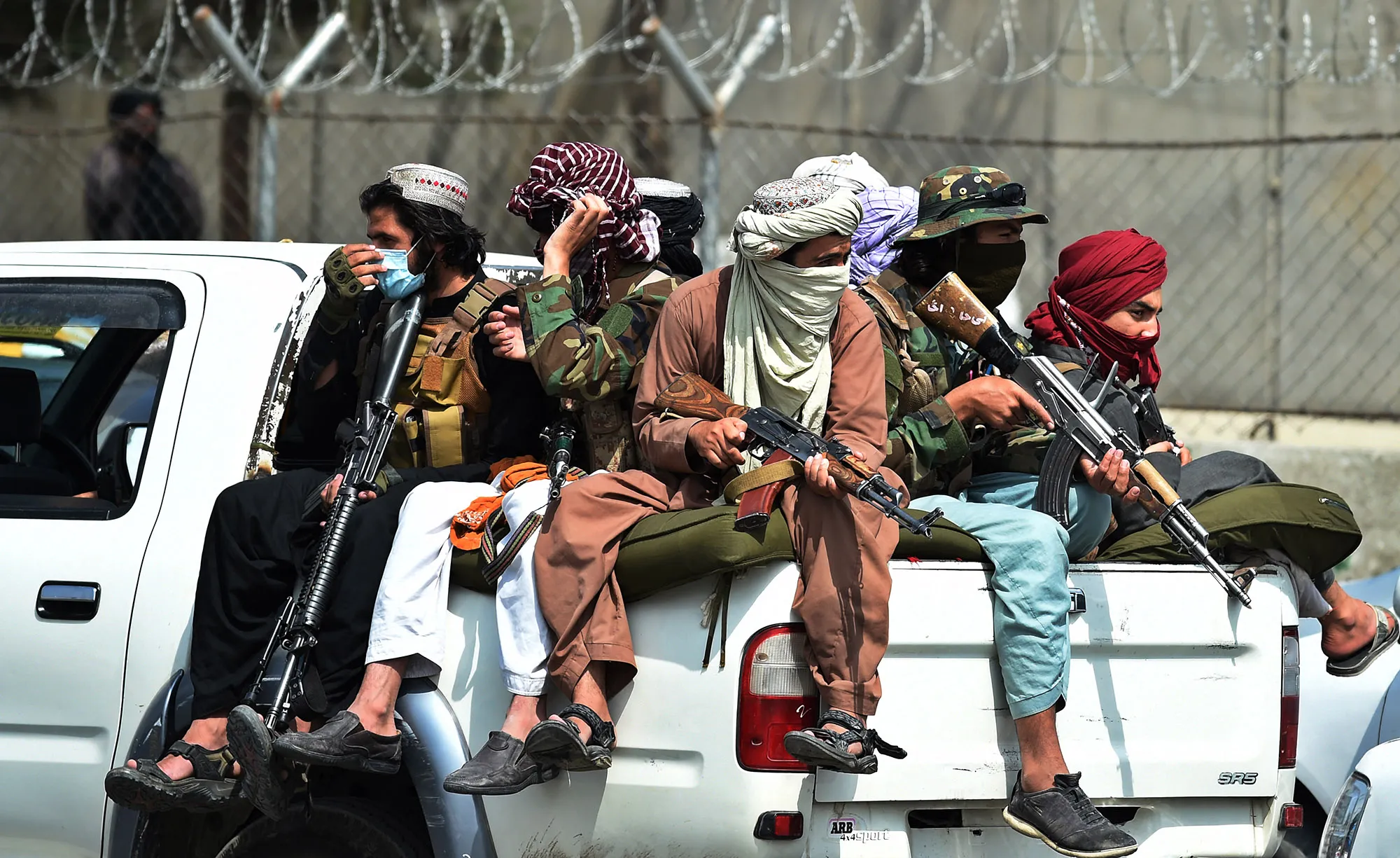 Taliban fighters guard outside the airport in Kabul on Aug. 31.