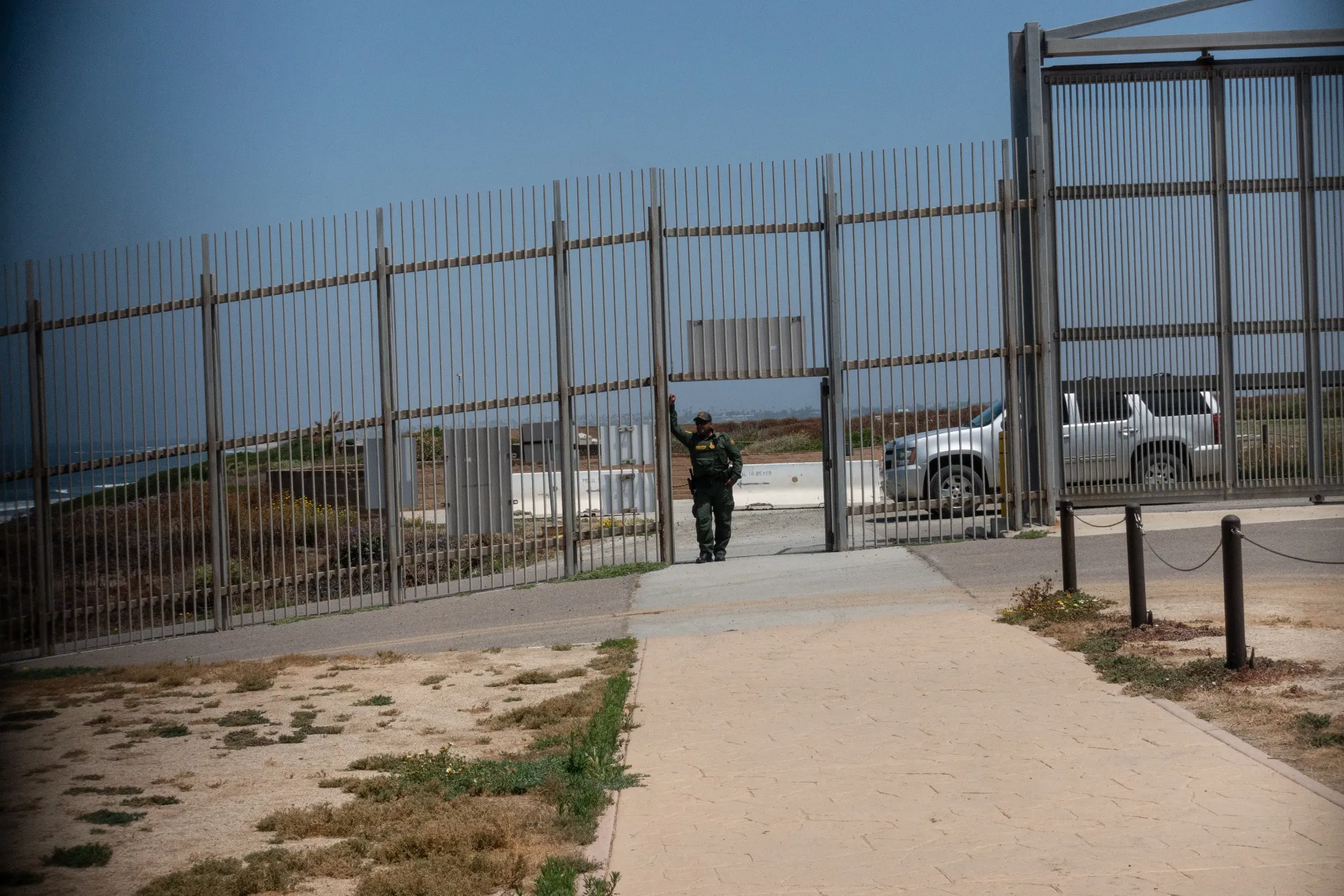 A U.S. Customs and Border Protection (CBP) officer stands near a section of the U.S. and Mexico border wall near the beach in Tijuana, Mexico.