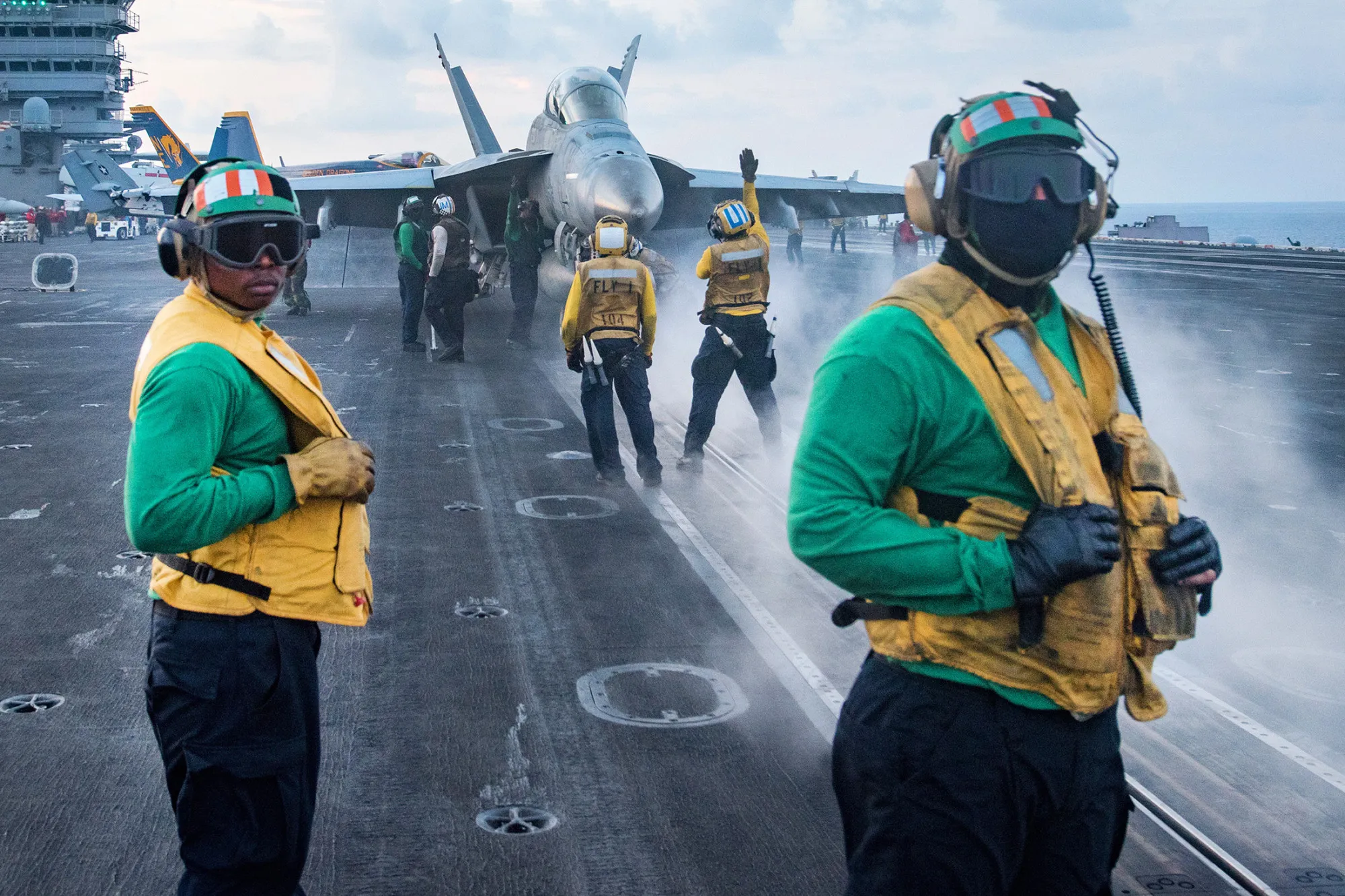 U.S. Navy Sailors conduct flight operations on the aircraft carrier USS Carl Vinson flight deck in the South China Sea, on April 8, 2017.
