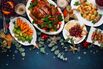 RF Concept of Christmas or New Year dinner with roasted chicken and various vegetables dishes.