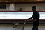 A customer passes an empty meat counter at a grocery store in Caracas, on Jan. 9.&nbsp;