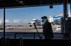 A worker cleans a window at Santiago International Airport, in Santiago, on April 20, 2020 during the new coronavirus, COVID-19, pandemic. - Latin America's biggest airline, the Brazilian-Chilean group LATAM, announced last Friday that the 95% reduction of its passenger operations announced in April will be extended until May due to the coronavirus crisis, which will cause a deeper impact than expected. (Photo by MARTIN BERNETTI / AFP) (Photo by MARTIN BERNETTI/AFP via Getty Images)