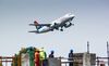 An airliner, operated by South African Airlines, flies over a construction site during take off from OR Tambo International Airport in Johannesburg.