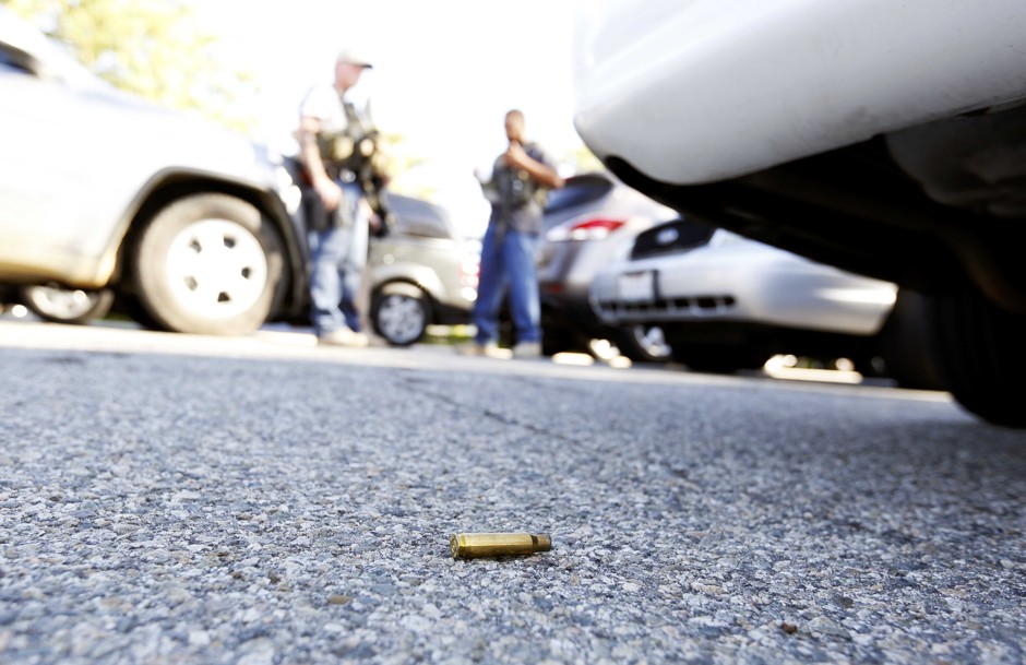 A spent cartridge lies on the ground as police officers secure the area where two shooters killed 14 people in San Bernardino, California.
