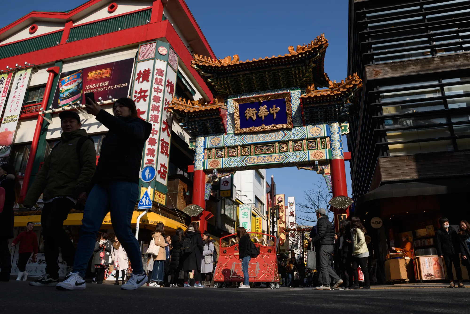 People walk through a gate at the Yokohama Chinatown area of Yokohama.