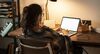 Teen girl doing homework on her laptop