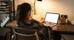 Teen girl doing homework on her laptop