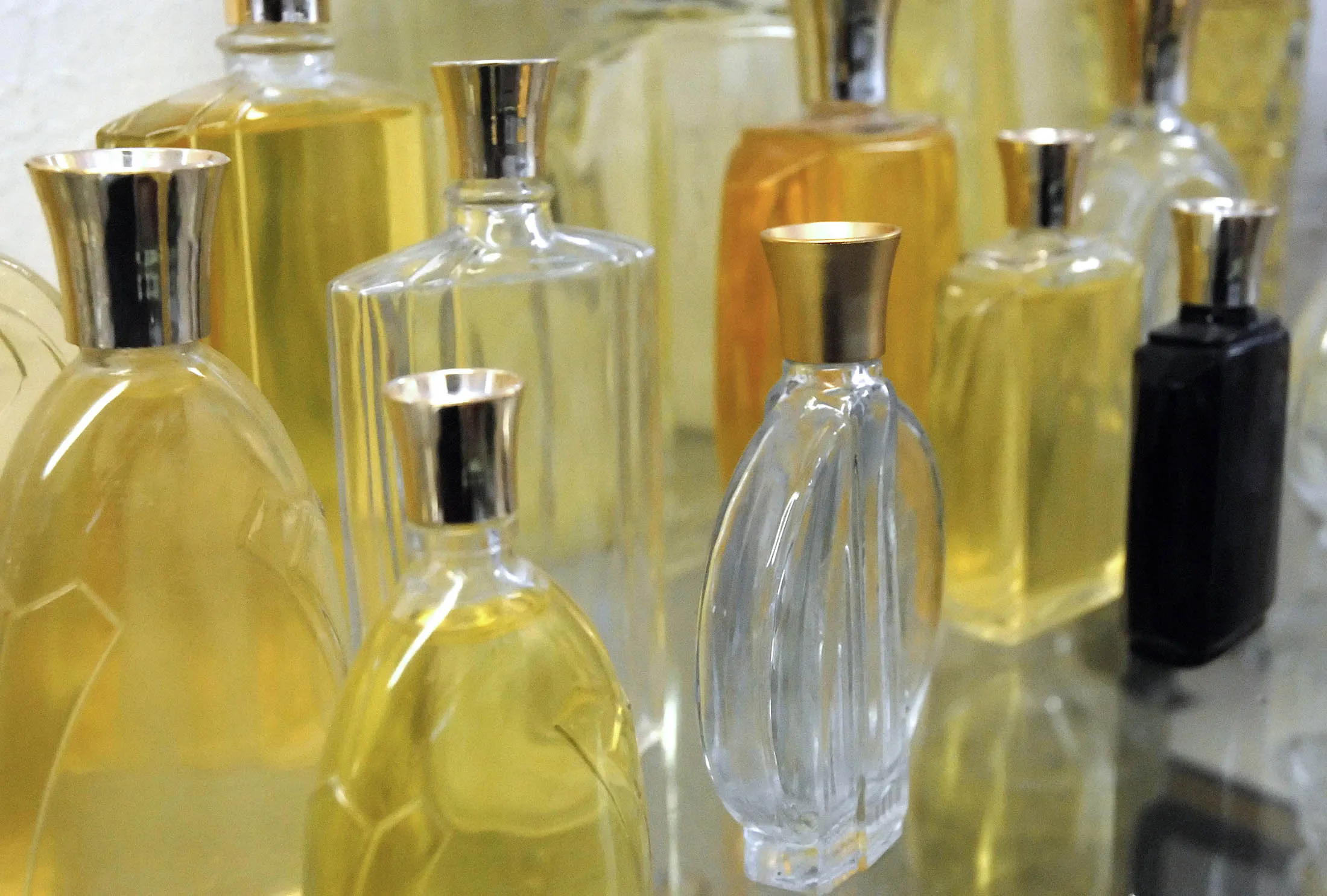 Bottles produced by Waltersperger sit on display at the factory in Blangy sur Bresles, France, on Monday, Nov. 26, 2007. Waltersperger is a small to medium sized factory, SME, which manufactures glass bottles and containers for cosmetics, perfume and spirits. The business, which has 35 employees, also produces domestic glassware.

