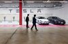 Customers look at Tesla Model S 90D electric vehicles parked at the company's charging station in the Starfield Hanam shopping complex in Hanam, Gyeonggi Province, South Korea.