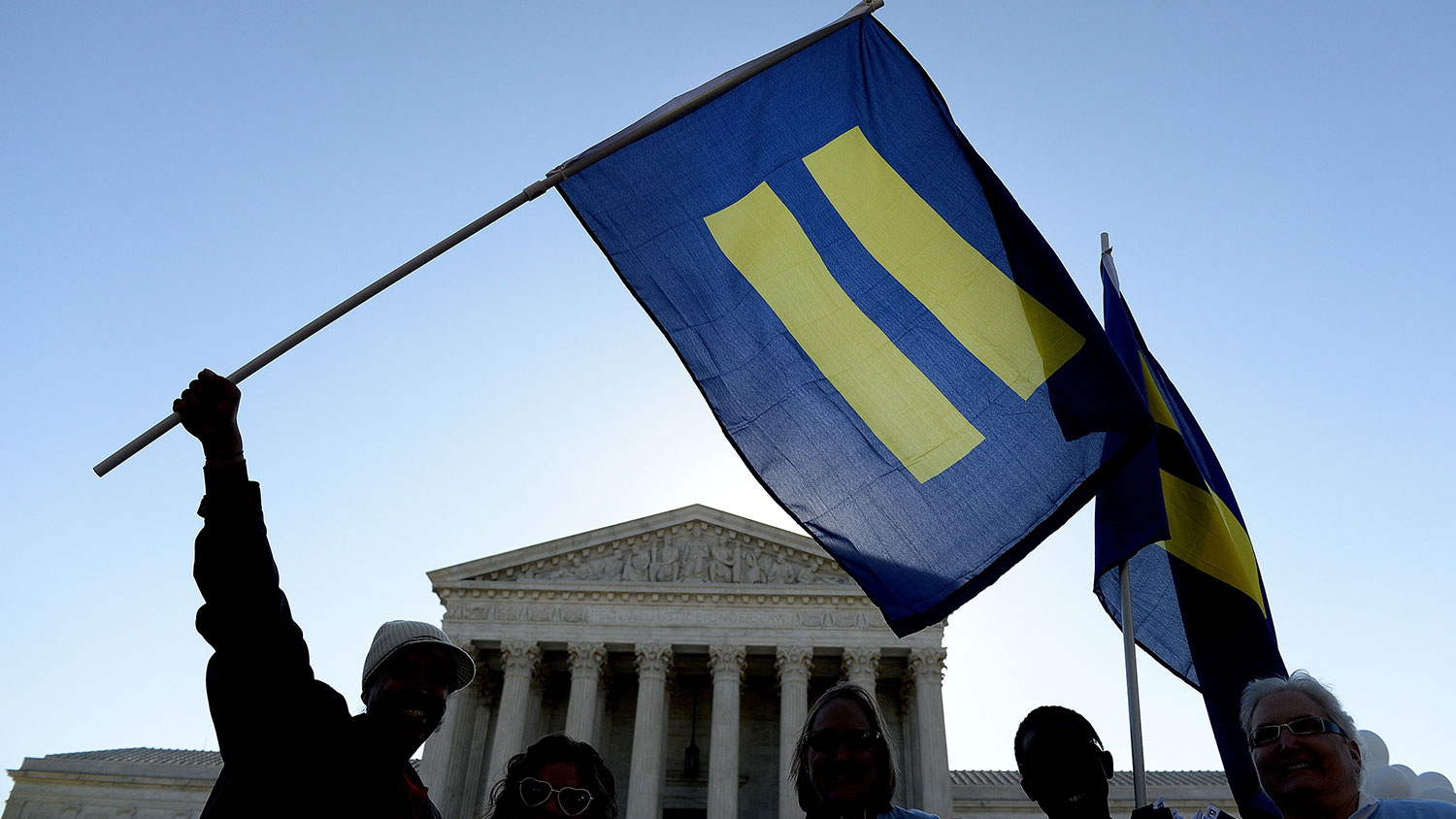 Protesters hold pro-gay rights flags outside the US Supreme Court on April 28, 2015 in Washington, DC.
