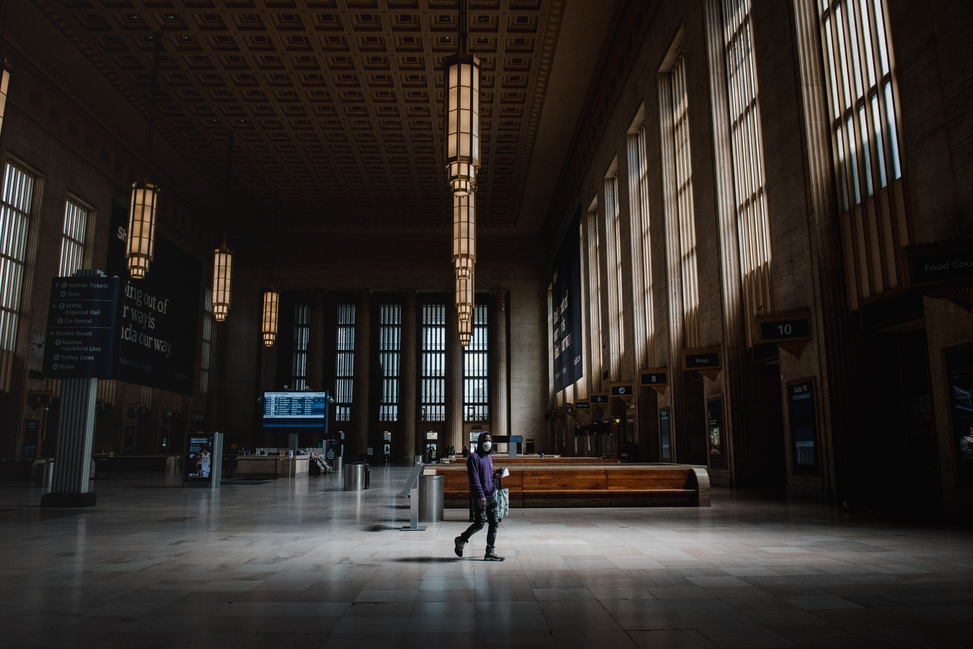 A man wearing a protective mask walks through an almost empty 30th Station in Philadelphia, Pennsylvania&nbsp;on&nbsp;April 15.
