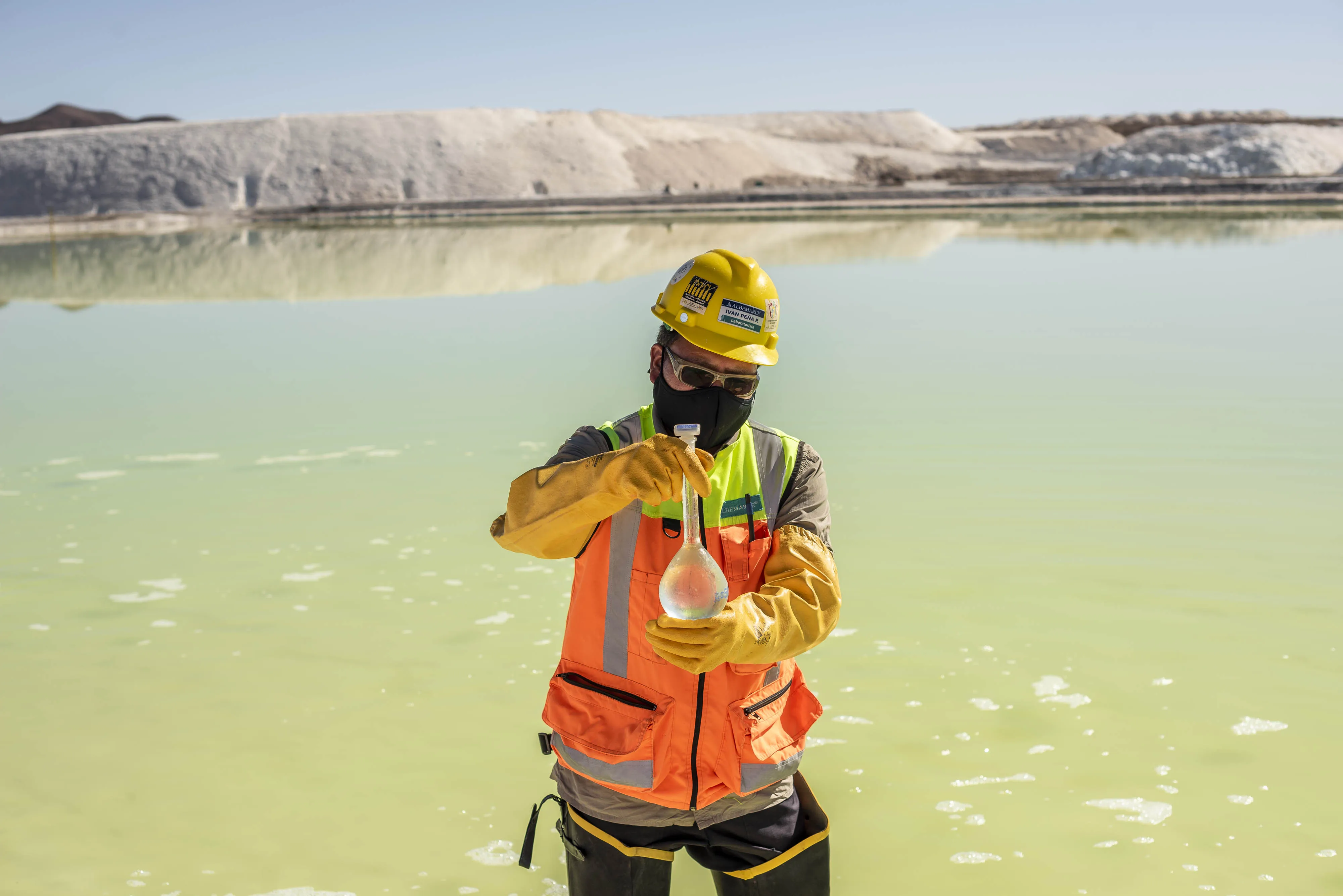 A mine worker takes water samples from a brine pool at the Albemarle Corp. Lithium mine in Calama, Antofagasta region, Chile, on Tuesday, July 20, 2021. Albemarle Corp., the world's biggest producer of lithium, is fast-tracking advanced forms of the metal that could result in better batteries for electric vehicles.