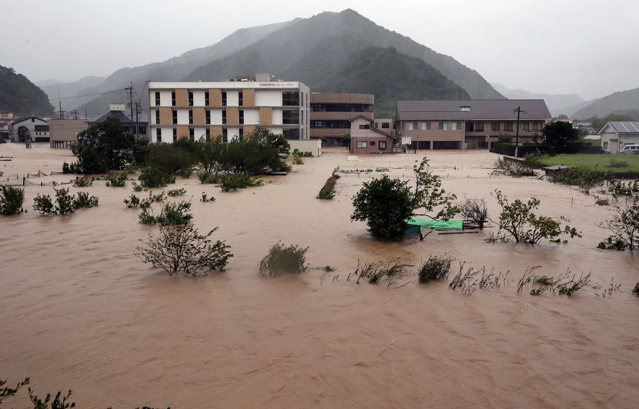 Residential streets are covered with water due to Typhoon Talim crossing from Kyusyu to Shikoku in Nobeoka City, Miyazaki Prefecture on Sept. 17.
