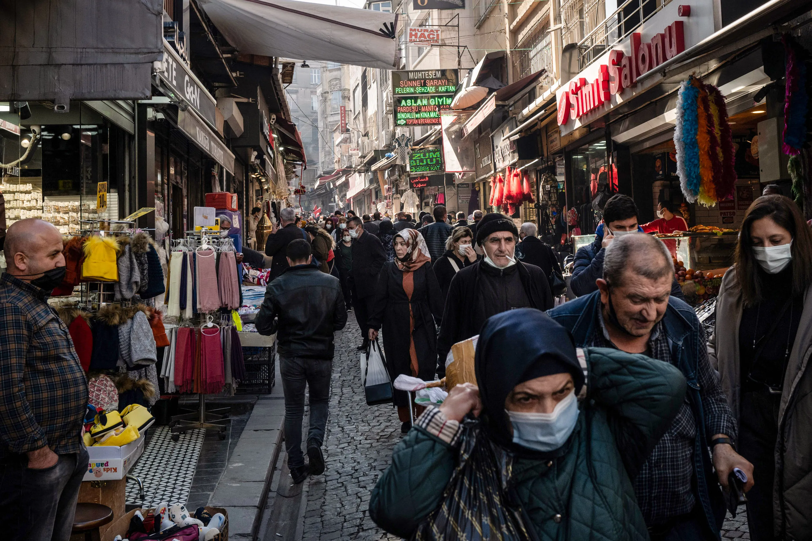 Shoppers walk along a busy commercial and retail street in the Fatih district of Istanbul.