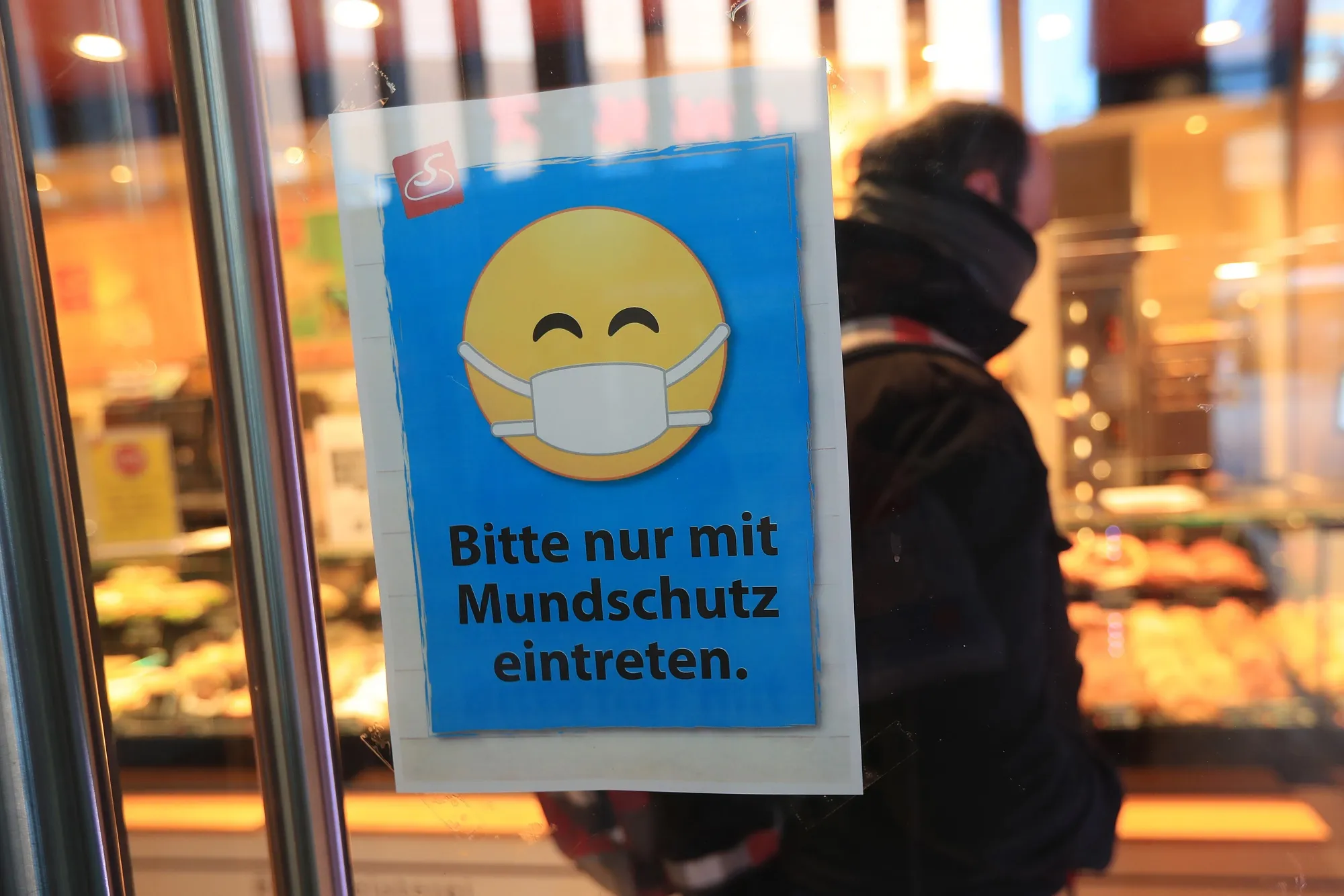A sign advises customers of coronavirus precautions in a bakery near the Volkswagen AG (VW) headquarter factory.