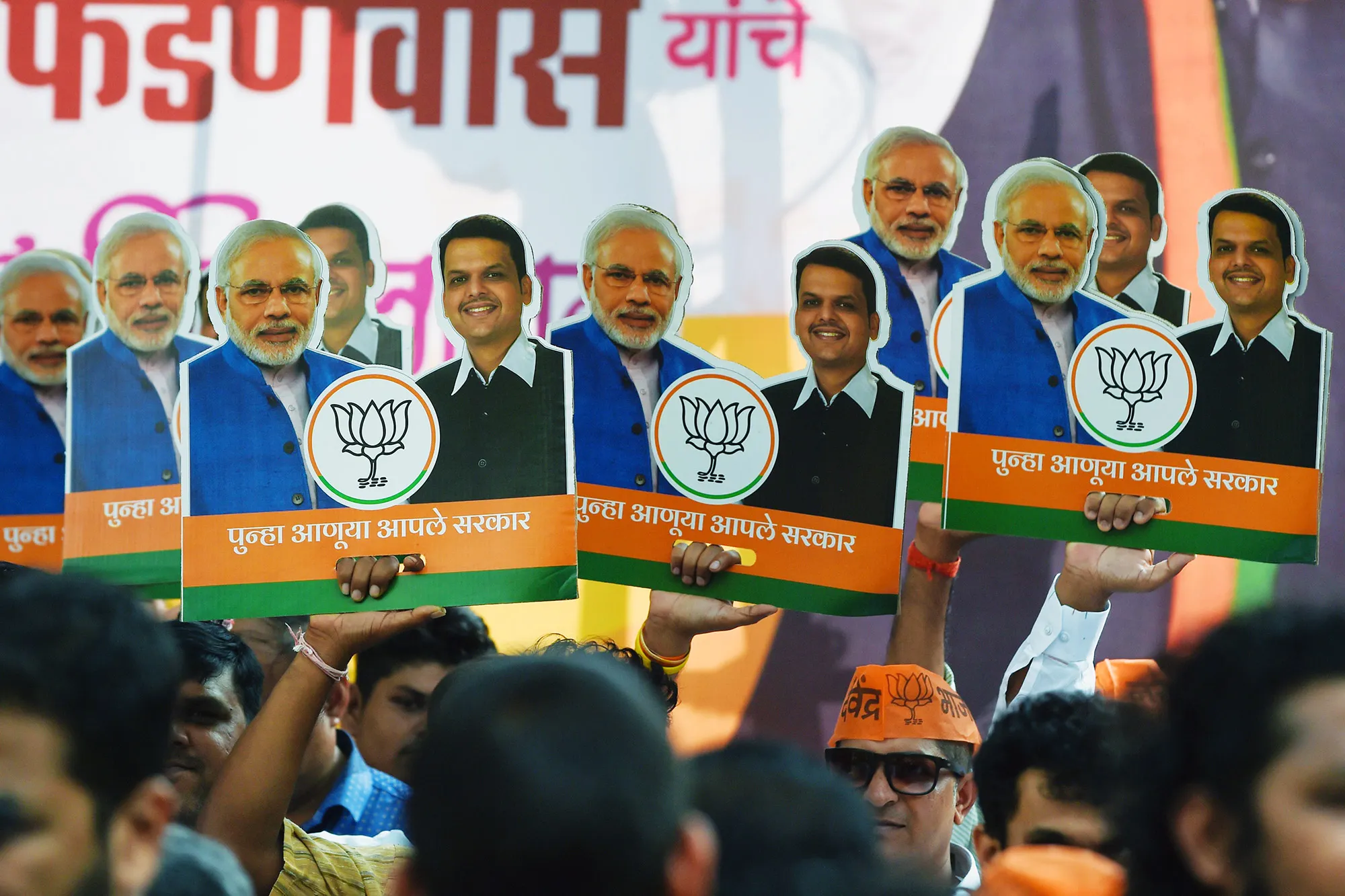 Bharatiya Janata Party (BJP) supporters celebrate with posters of Narendra Modi and&nbsp;Devendra Fadnavis&nbsp;in Mumbai on Nov.&nbsp;23.&nbsp;