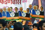 Bharatiya Janata Party (BJP) supporters celebrate with posters of Narendra Modi and Devendra Fadnavis in Mumbai on Nov. 23. 