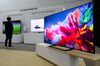 A visitor looks at a Samsung Electronics Co. QLED television.