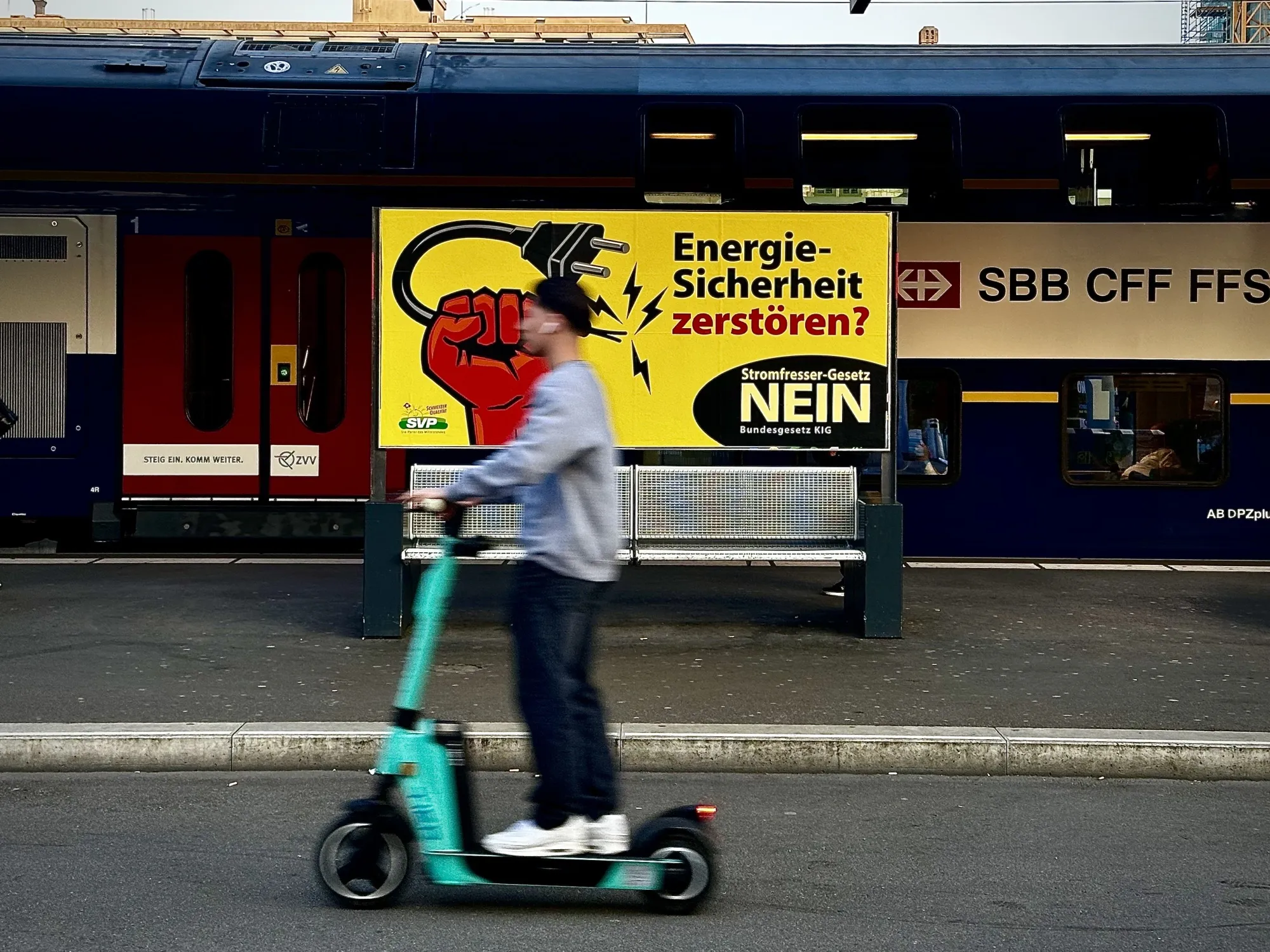 A scooter-driver passes a billboard for the ‘no’-campaign at Zurich-Oerlikon train station in early June.