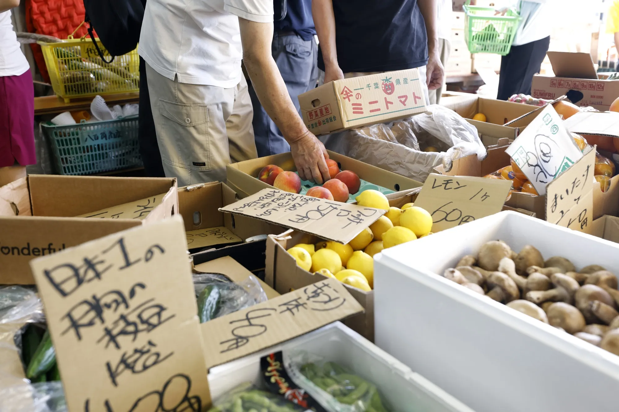 Customers shop at a fruit and vegetable stall in Tokyo, on Aug. 2. 