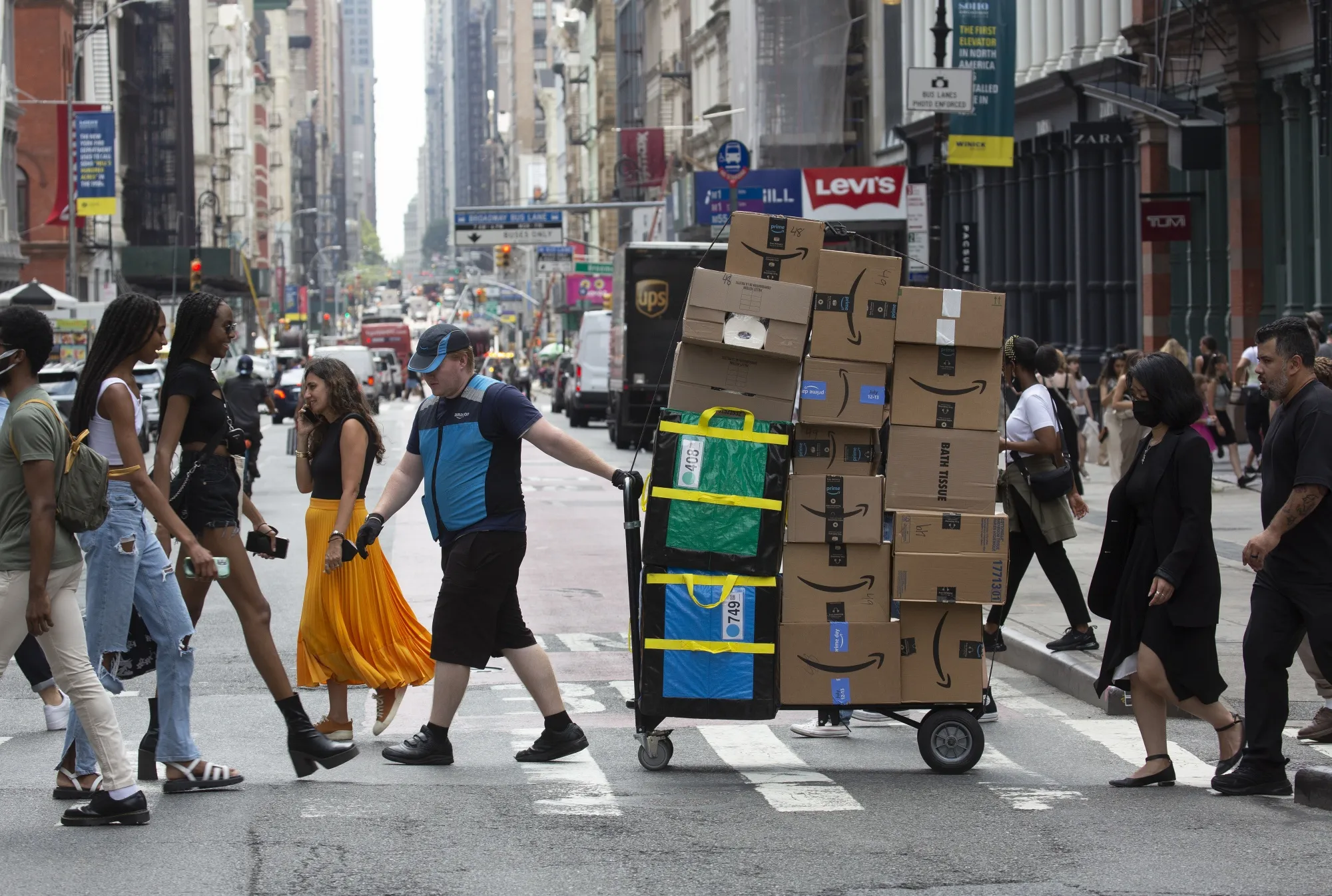 A worker delivers packages on Amazon Prime Day in New York.