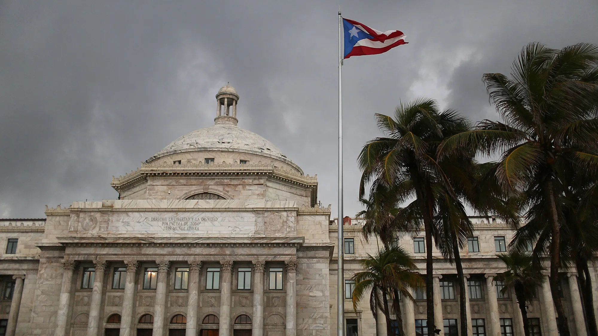 SAN JUAN, PUERTO RICO - JULY 01: The Puerto Rican flag flies near the Capitol building as the island's residents deal with the government's $72 billion debt on July 1, 2015 in San Juan, Puerto Rico. Governor of Puerto Rico Alejandro GarcÃ­a Padilla said in a speech recently that the people of Puerto Rico will have to make sacrifices and share the responsibilities to help pull the island out of debt.
