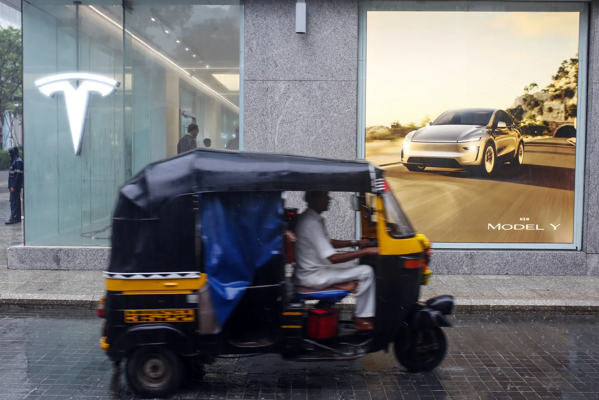 An auto rickshaw outside the new Tesla store at Bandra Kurla Complex&nbsp;in Mumbai.