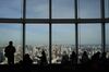 Visitors look out from the observation deck of the Roppongi Hills Mori Tower, operated by Mori Building Co., in Tokyo, Japan, on Monday, March 18, 2019.