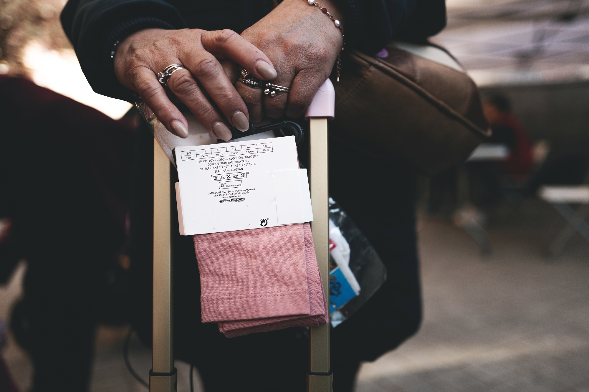 A woman holds a pair of new socks distributed at the Fundacion Madrina in Madrid, Spain, on Friday, March 13, 2026.