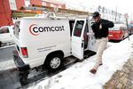 A Comcast field service technician arrives to install cable service at a residence in Reading, Pa., on Jan. 19, 2011.
