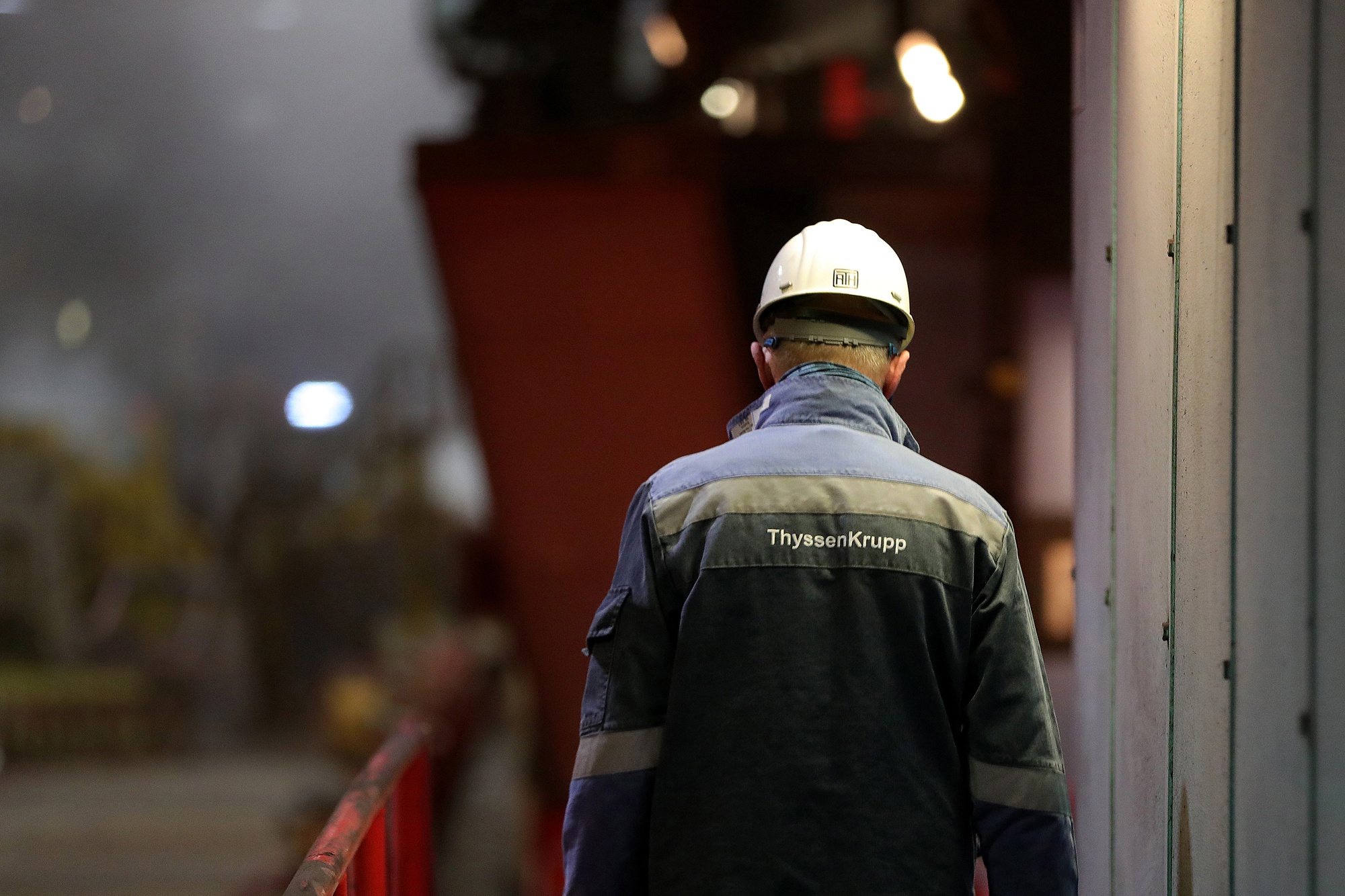 An employee walks along the steel rolling production line at the Thyssenkrupp AG metals plant in Duisburg.