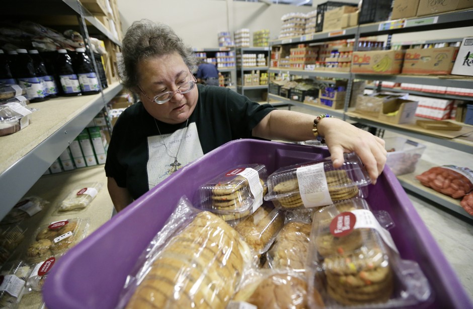 A volunteer unloads deliveries at a food bank that serves greater Des Moines, Iowa.