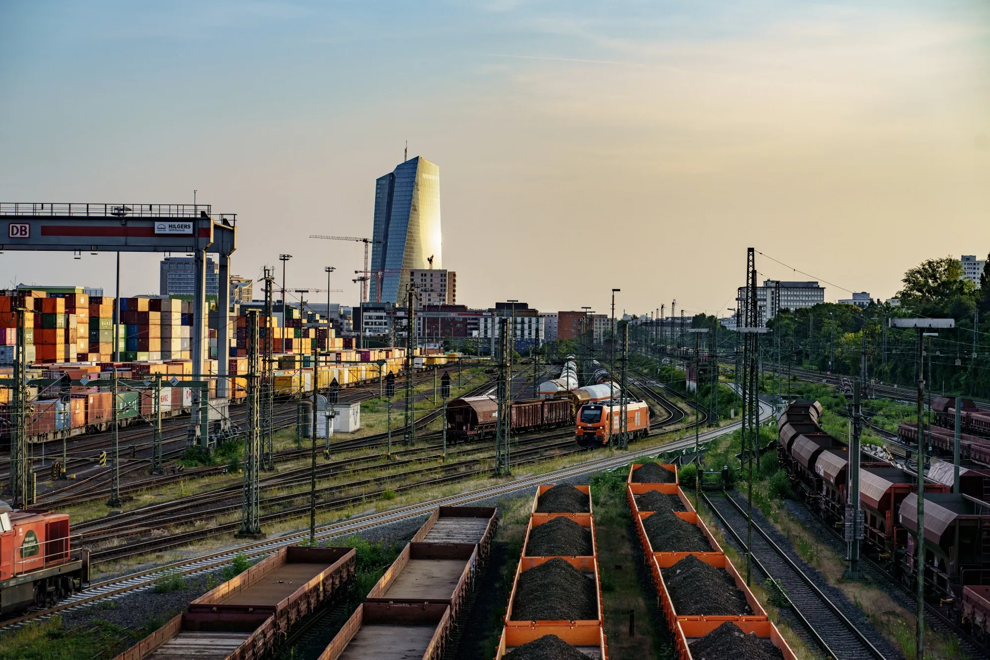 The European Central Bank beyond coal trucks and containers at a freight terminal in Frankfurt.