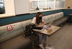 A student sits alone inside the George Sherman Union Food Hall at Boston University in Boston on Sept. 23.