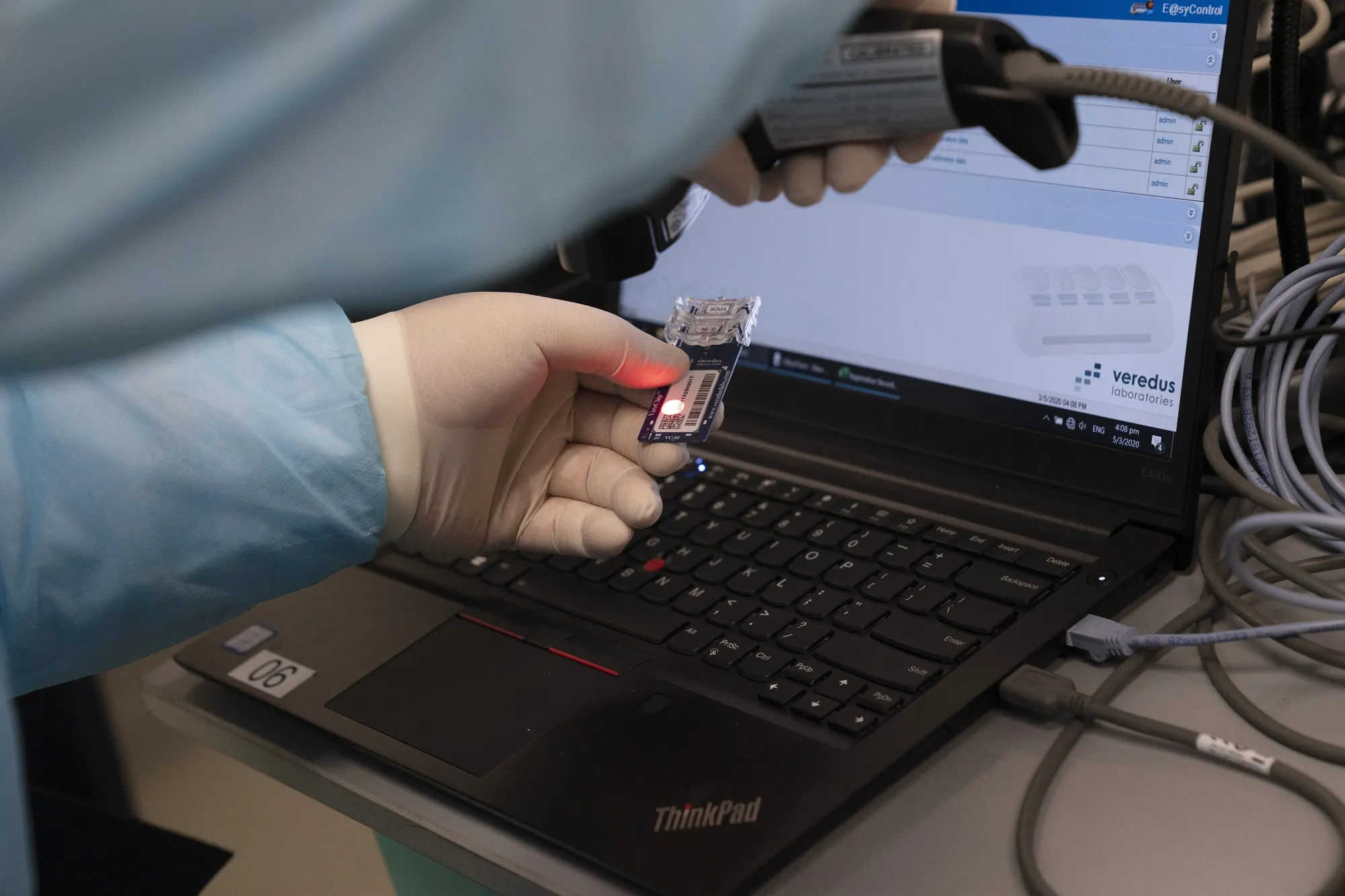 A technician scans a chip on a Covid-19 test kit in Singapore.
