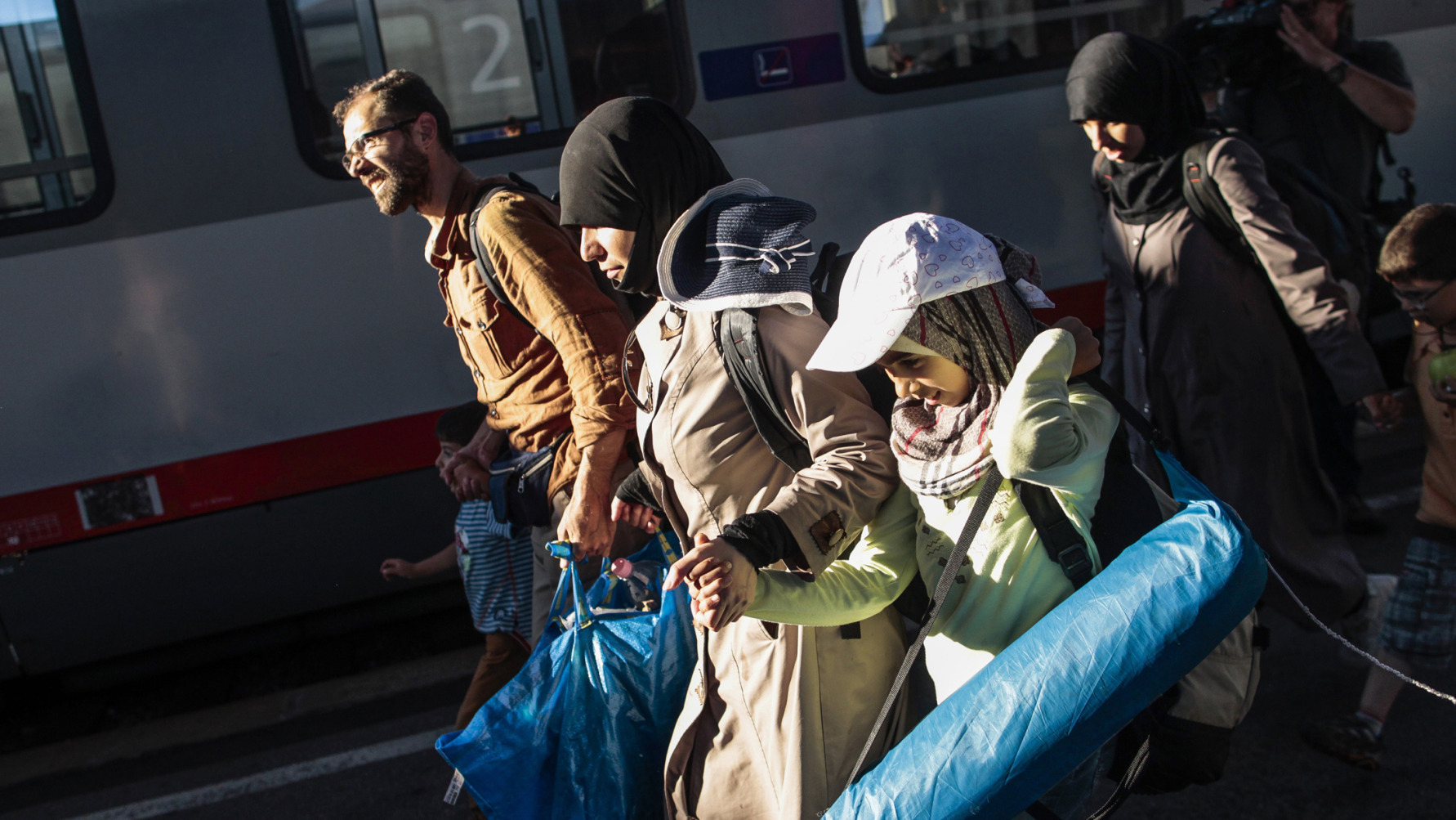 Migrants walk on a platform after arriving from Budapest, at Vienna's Westbahnhof railway station, on Aug. 31.
