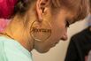 A woman wearing an "Abortion" earring is seen inside the