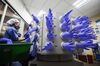Employees attach latex gloves to an air compressor as other gloves are inflated in the air-leak test room at a Top Glove Corp. factory in Setia Alam, Selangor, Malaysia, on Thursday, Dec. 3, 2015. Top Glove, the world's biggest rubber-glove maker commanding over a quarter of the market, expects to conclude at least one acquisition in the fiscal year through August as the Malaysian company seeks to maintain record earnings momentum.