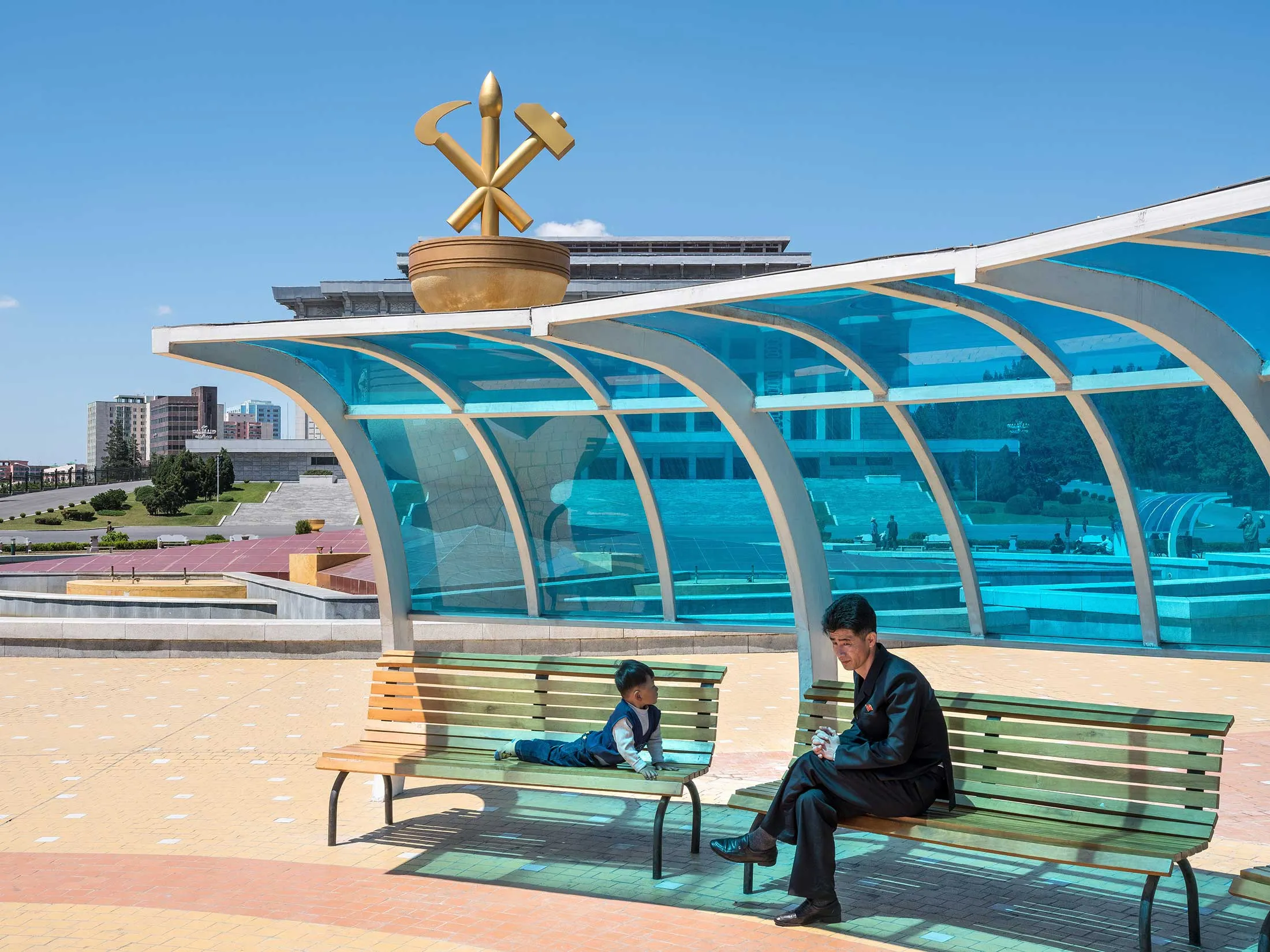 A father and son in front of Pyongyang’s April 25 House of Culture, the site of political and military gatherings.