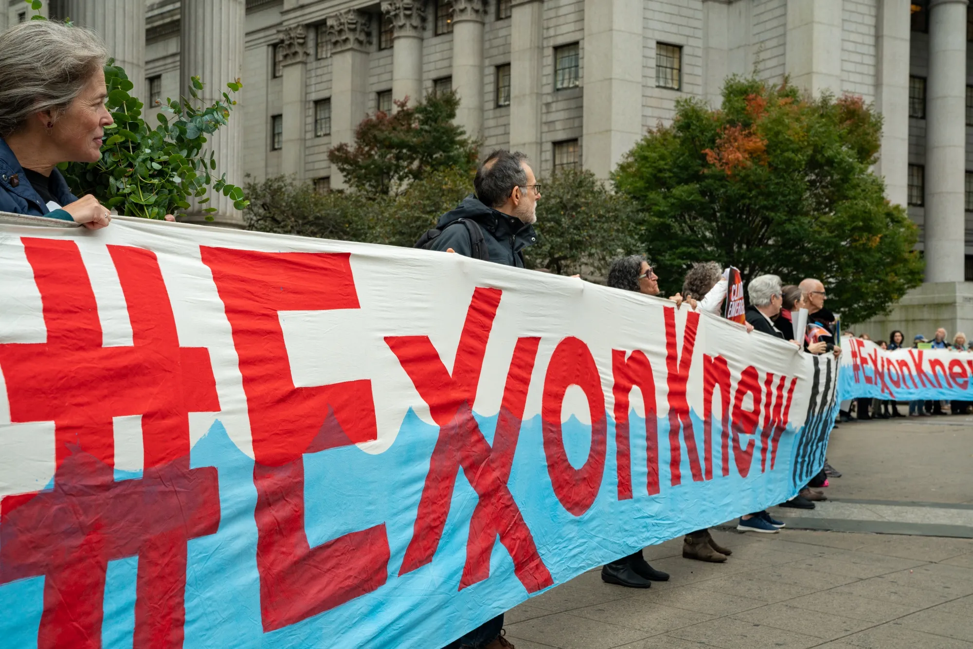 Demonstrators outside New York State Supreme Court in lower Manhattan on Oct. 22, the first day of the Exxon Mobil trial.&nbsp;