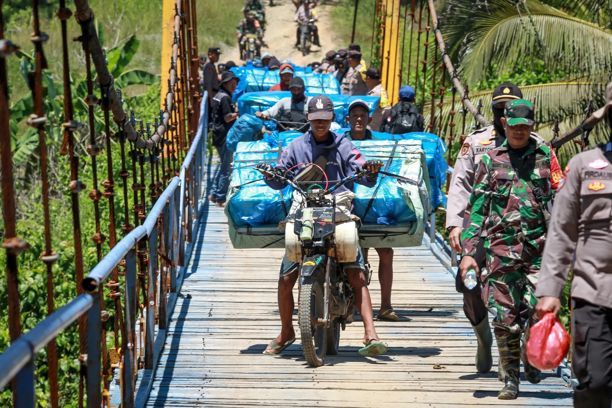 The logistics unit of the General Elections Commission delivers election materials by motorbike to remote polling stations in Lampung on Feb. 11.
