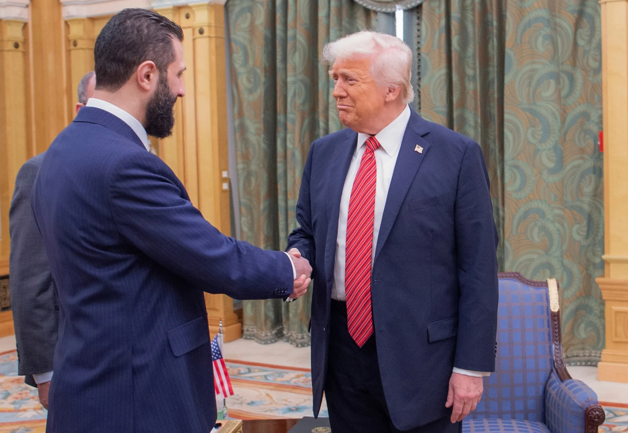 President Donald Trump, right, shakes hands with Syria's interim President Ahmad al-Sharaa, in Riyadh, Saudi Arabia on May 14, in this photo released by the Saudi Royal Palace.