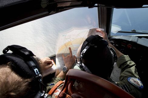 Flight Lieutenant Jayson Nichols looks at a map as he flies over the southern Indian Ocean in search of the missing Malaysian Airlines flight MH370.