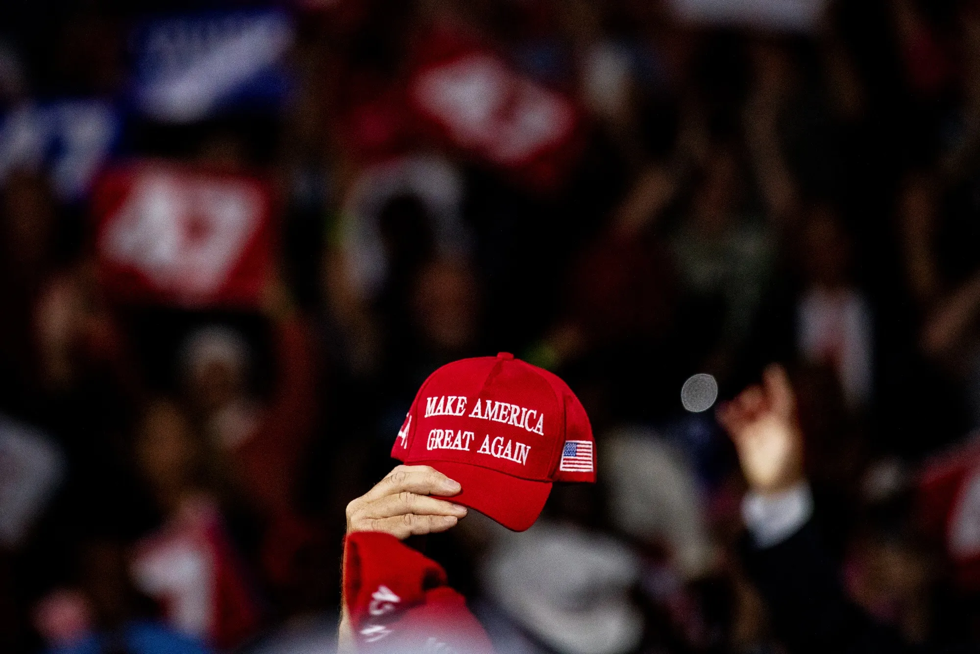 Attendees wave their hats during a town hall event with former US President Donald Trump&nbsp;