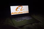 The Alibaba Group Holding Ltd. logo is seen on a laptop screen in an arranged photograph.
