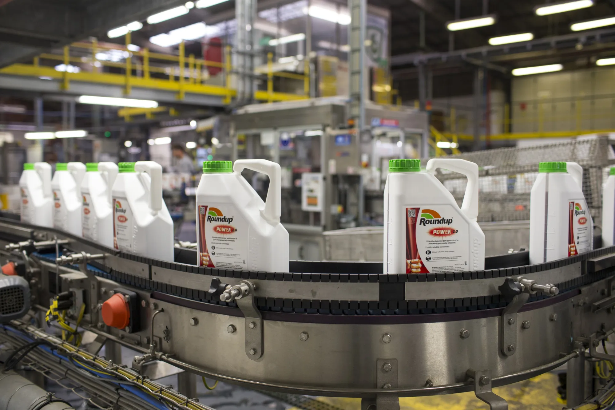 Bottles of Roundup weed killer move along the production line.