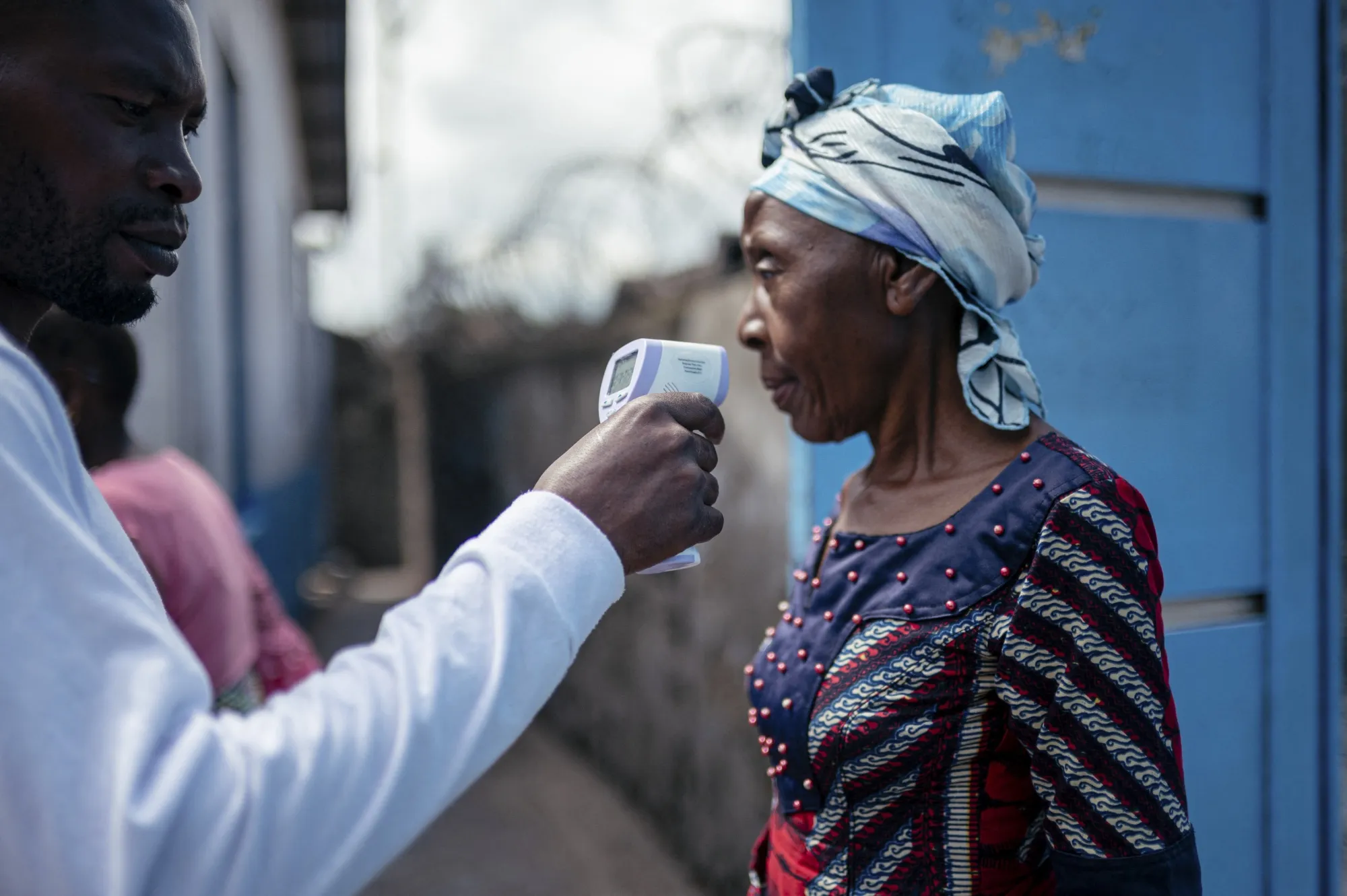 A health official checks a visitor’s temperature at the entrance of a hospital in Goma, Democratic Republic of Congo, on May 17.